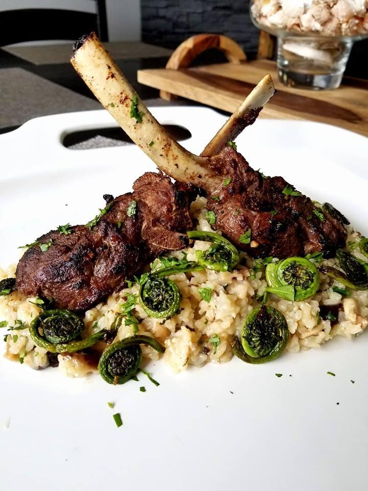 Frenched venison rack with mushroom risotto and sautéed fiddleheads