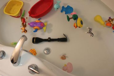 Bath tub filled with toys and a scope