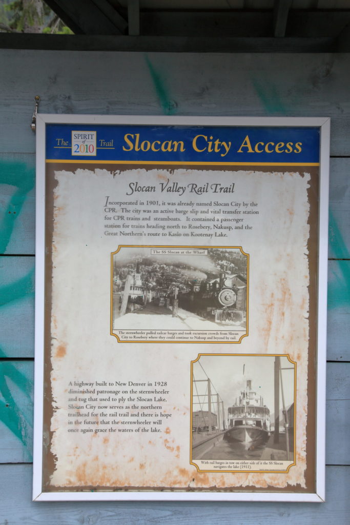 A sign telling the history of the Slocan Valley Rail Trail. The Slocan Valley Rail Trail Society took over stewardship of the right-of-way in 1994.