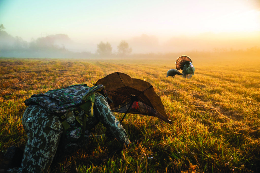 Hiding behind a turkey decoy or fan to stalk in closer to your quarry is known as reaping. Photo by Vista Outdoors.