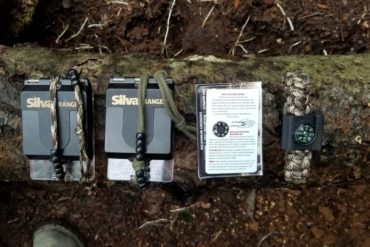 This is my bare minimum must-haves: one compass in my pack, one in my pocket or binocular harness, a Brunton floating disc compass in my binocular harness and a button compass on my paracord bracelet. Not shown is the magnetized needle I have taped to the back of my belt knife sheath as a last resort.