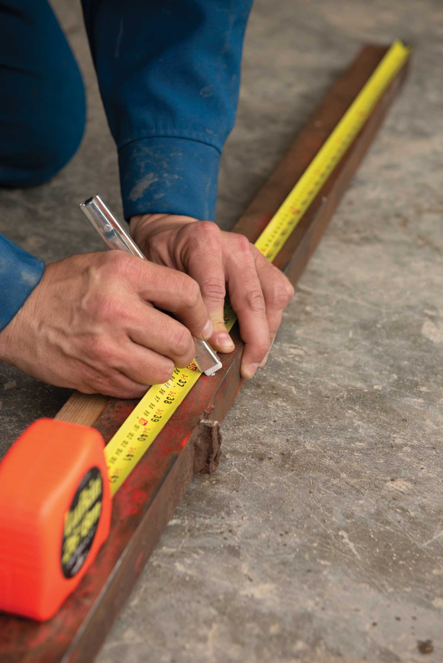 Step 2, layout: Metal parts measured and marked in preparation for cutting. 