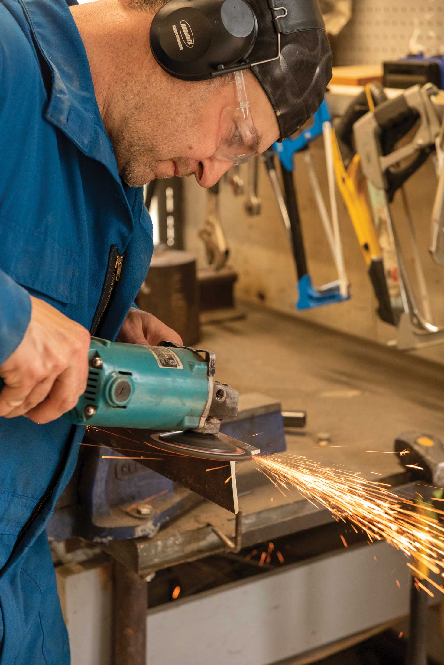 Step 4, metal preparation: Good metal preparation is crucial to good welds, especially when using recycled metal. Here, a wire brush on an angle grinder removes old paint and rust.