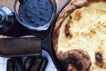 Cast Iron Dutch Baby With Huckleberry Sauce. Credit: Raeanne O’Meara.