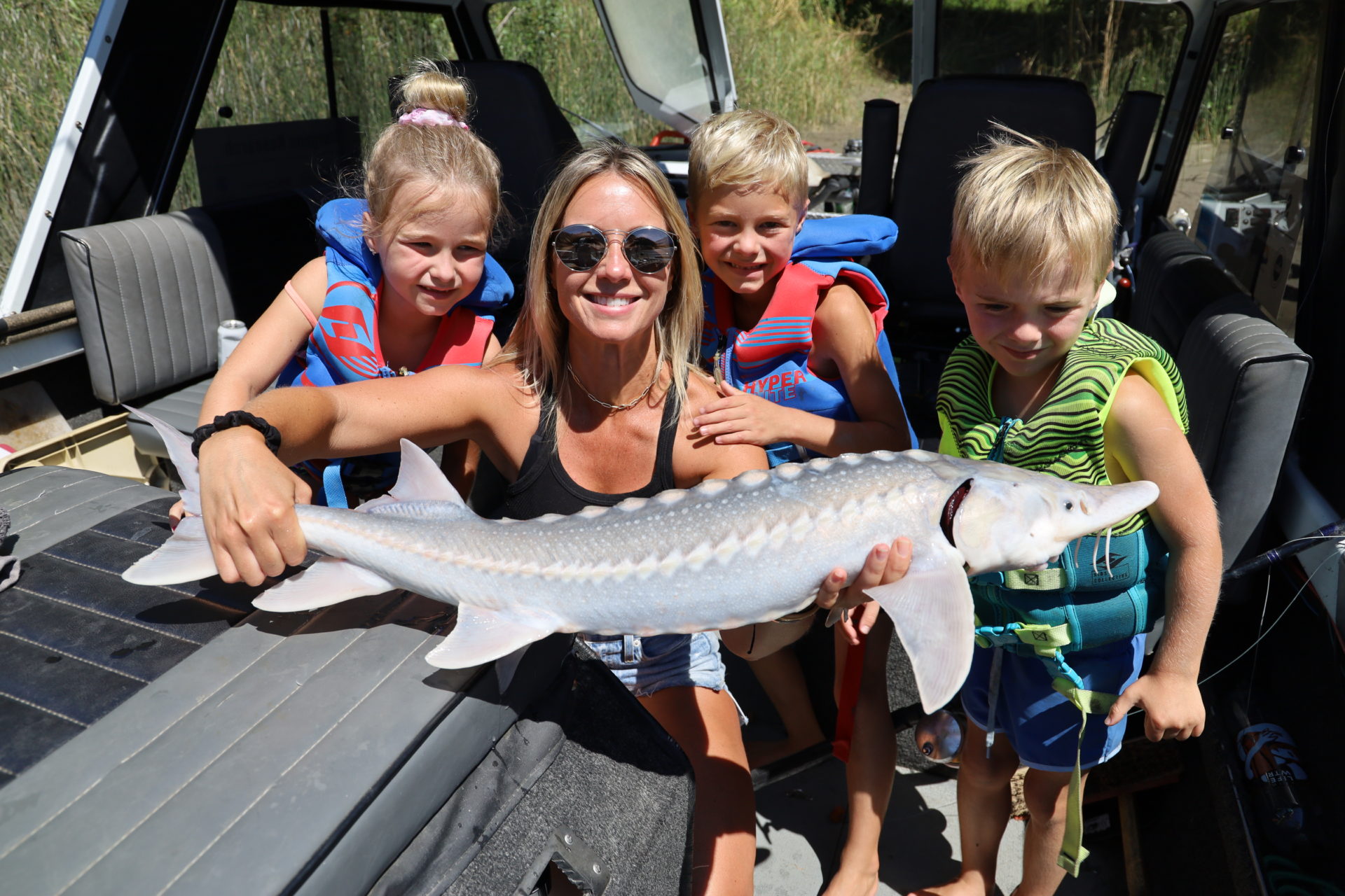 Brandy Ladd holding a juvenile sturgeon. It's important to educate the public about sturgeon and the issues this species is facing.