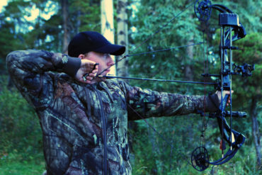 Man bow hunting