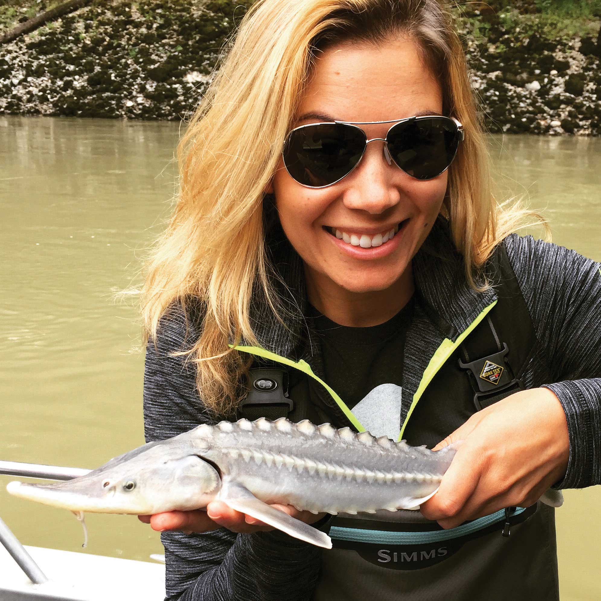 Mariko Izumi with a juvenile sturgeon. The Habitat Conservation Trust Foundation has funded the juvenile monitoring program, the first of its kind.