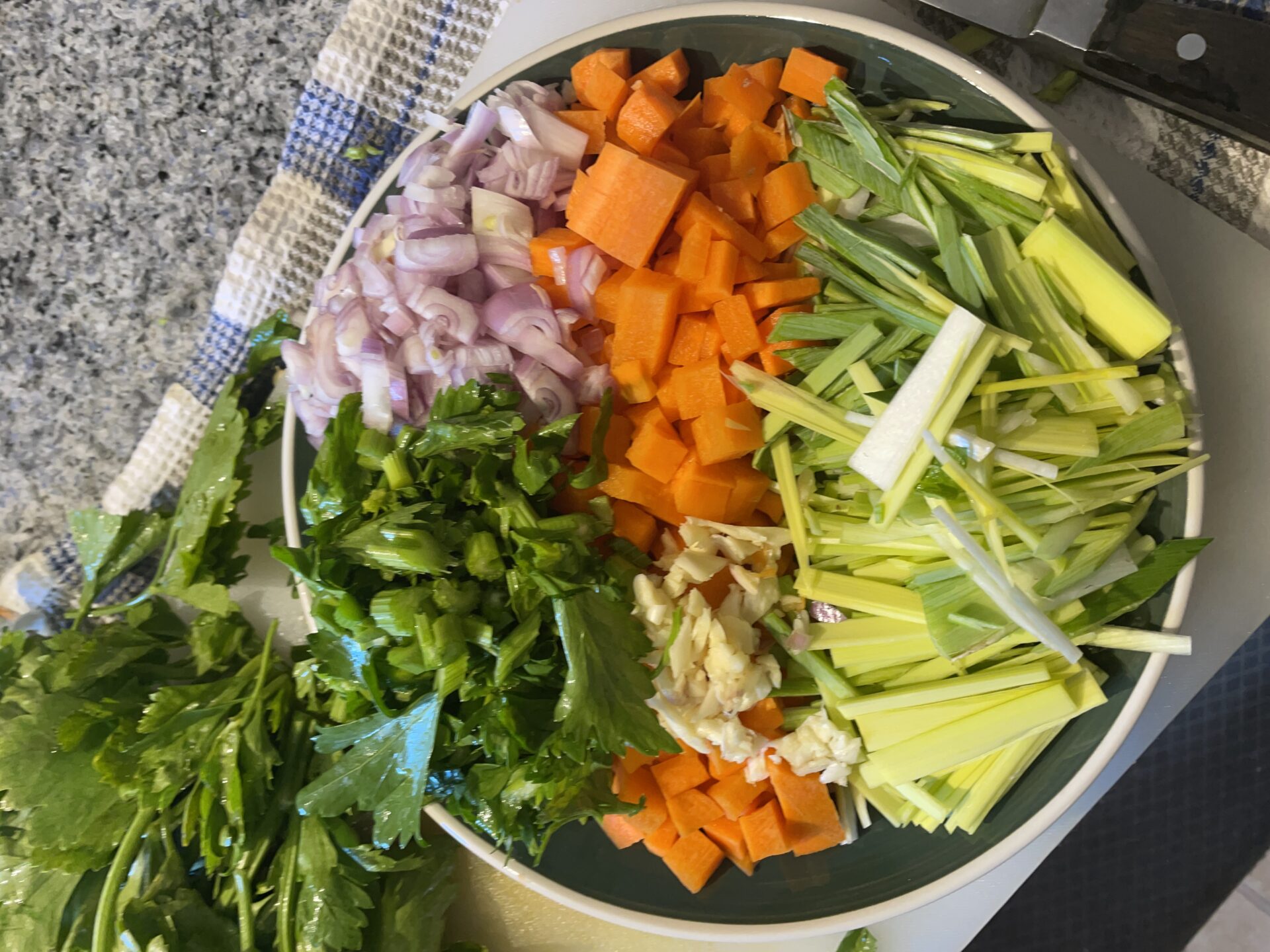 A combination of leeks, garlic, carrot, shallots, and celery leaves are perfect for braised rabbit.