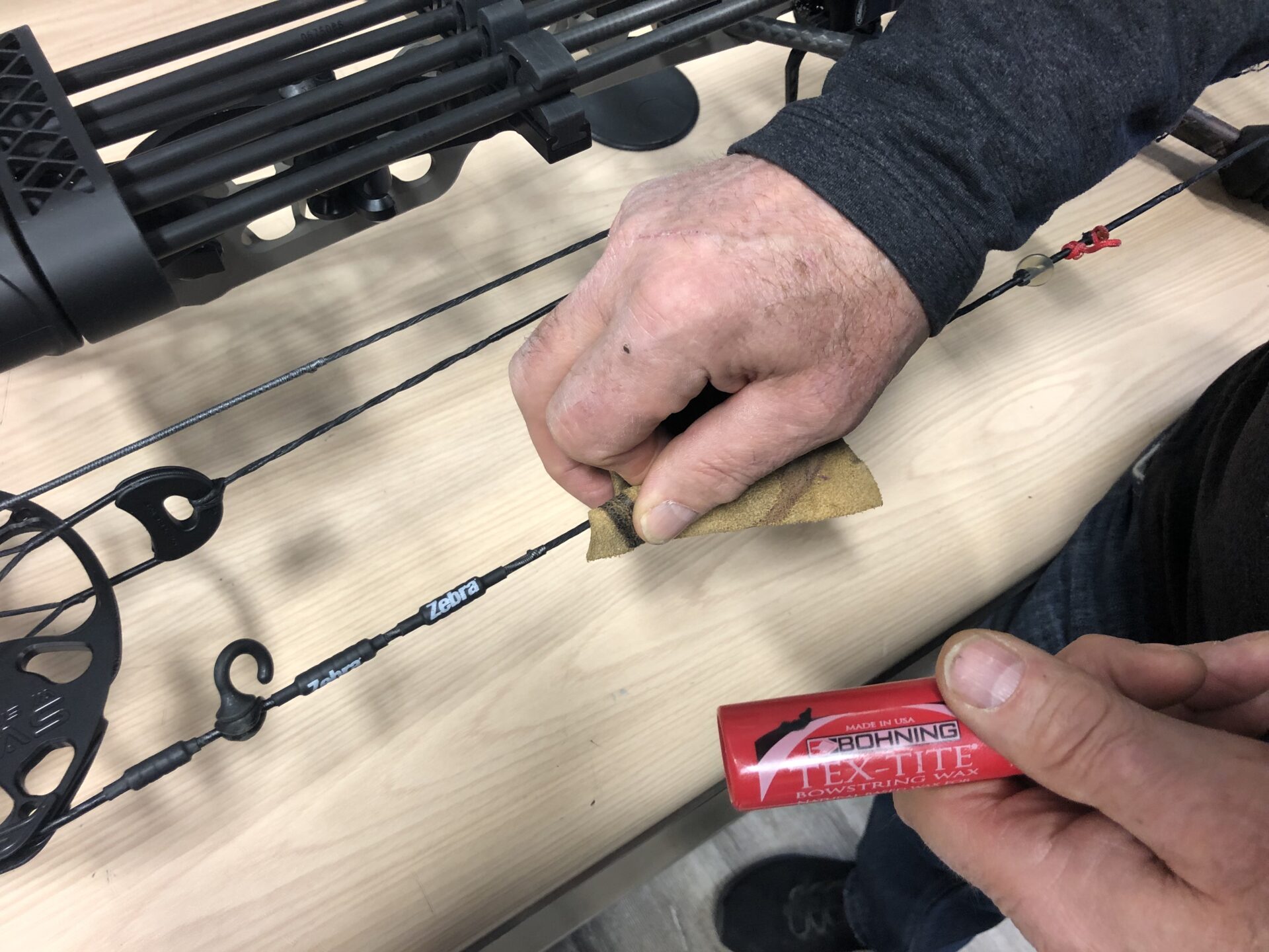 Use a small piece of leather or a leather glove to wax your strings.